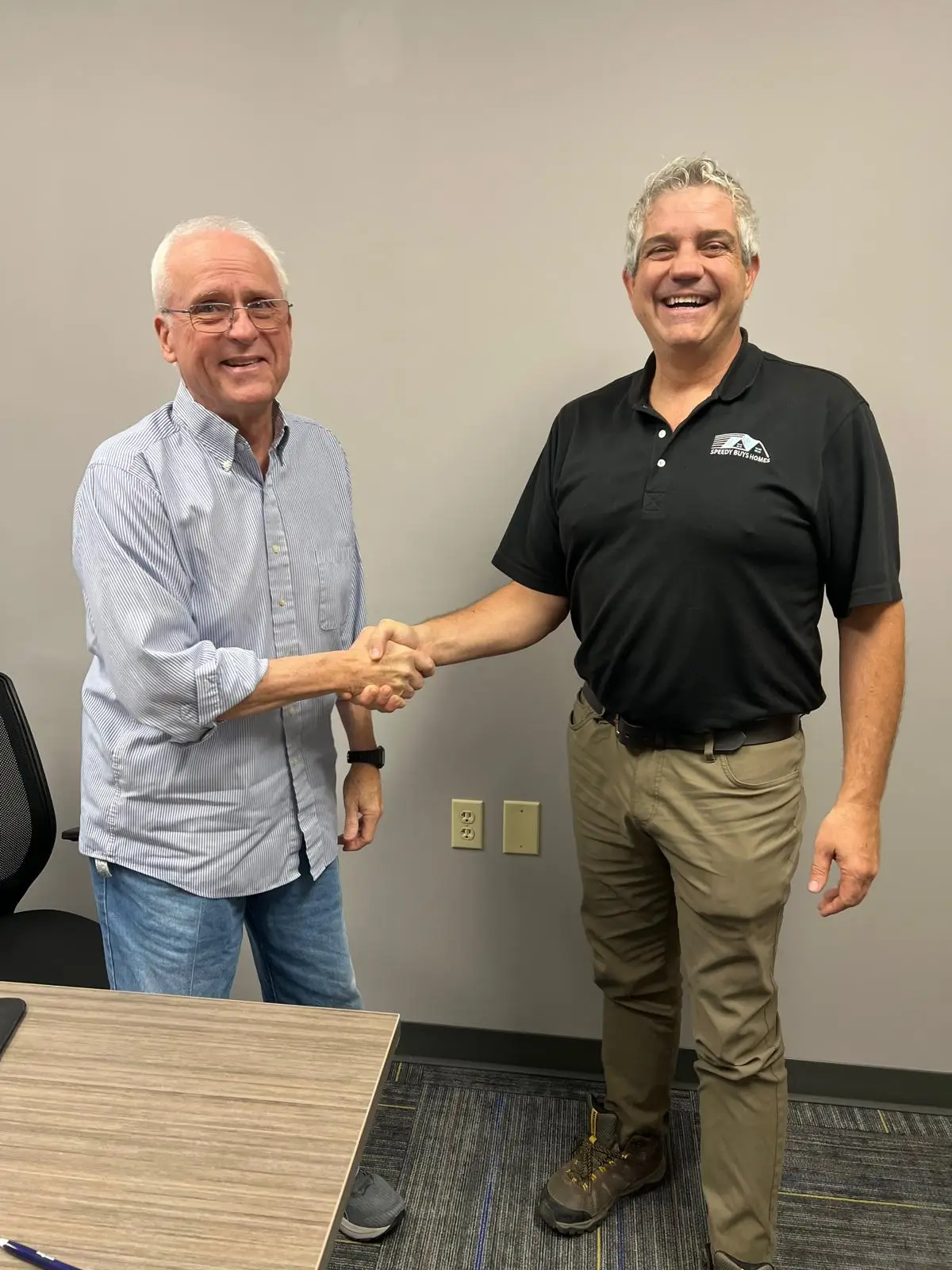 Ryan Clements shaking hands with a Speedy Buys Homes client